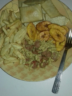 A picture of Fried yam, chips, fried plantain n egg n sausage sauce.