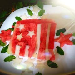 A picture of Red yellow melon dessert in the shape of a flag.