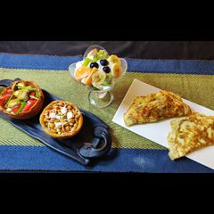 A picture of Oats fruits, sprouts, roasted veggies,cheese omelette.