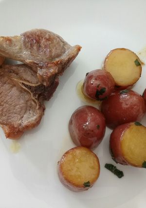 A picture of Minted red russet potatoes with grilled lamb.