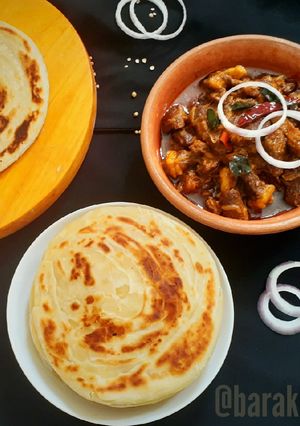 A picture of Kerala style Beef fry with Malabar Paratha.
