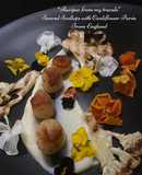 Seared scallops with cauliflower puree, chargrilled cauliflower and edible flowers