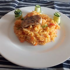 A picture of Carrot Rissoto with Chicken and cucumbers.
