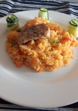 A picture of Carrot Rissoto with Chicken and cucumbers.