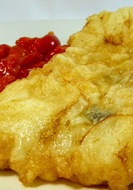 Una foto de Bacalao rebozado acompañado de pimientos