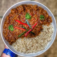 A picture of Slow Cooked Lamb Madras w/ Rice.