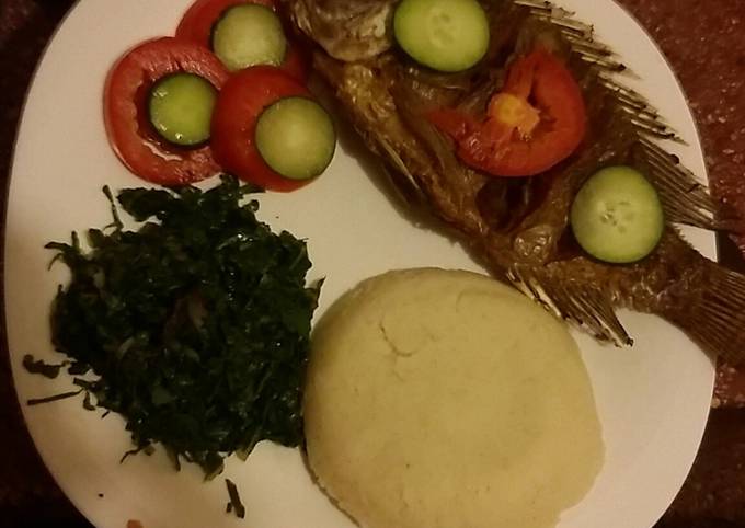 Deep fried whole served with Ugali and spinach