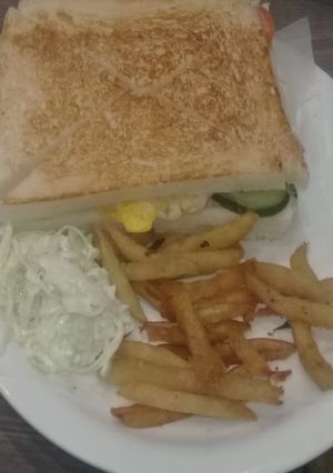A picture of Sandwich with fries.