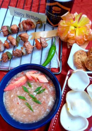 A picture of Hot n sour soup with shashlik sticks.