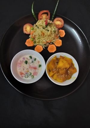 A picture of Fried rice doi potato raita and salad.