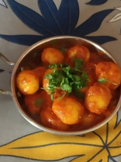 A picture of Potatoes in hot red sauce.