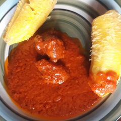 A picture of Boiled plantain with tomato stew.