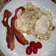 A picture of Over Easy Fried Eggs and Bacon.