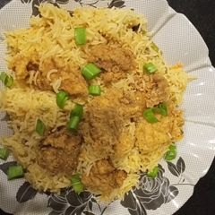 A picture of Arabian rice with chicken pops.