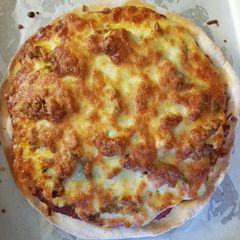 A picture of Completely homemade chicken madras pizzas.