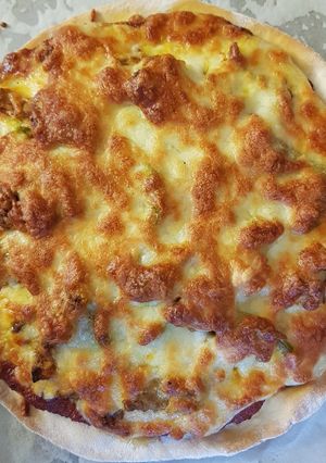 A picture of Completely homemade chicken madras pizzas.