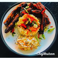 A picture of Lime and chilli rice with sticky spicy pork ribs and homemade coleslaw.