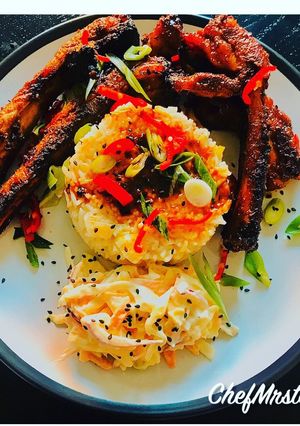 A picture of Lime and chilli rice with sticky spicy pork ribs and homemade coleslaw.