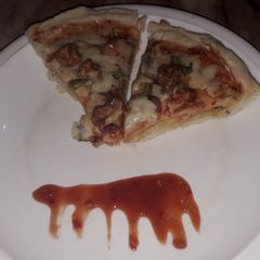 A picture of Chicken tikka pizza.