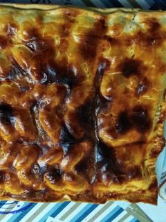 Una foto de Empanada de bacon, dátiles y queso