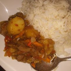 A picture of Potato and chicken sauce wit white rice.