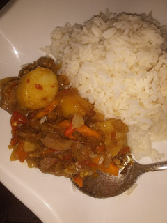 A picture of Potato and chicken sauce wit white rice.