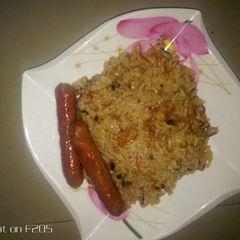 A picture of Rice and beans with sausage.