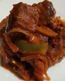 Masa de cerdo frita con salsa de tomate, pimiento y cebolla