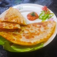Indian style cheese paneer veg pizza paratha A picture of Indian style cheese paneer veg pizza paratha.