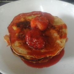 A picture of Vegan Pancakes with Strawberry sauce.