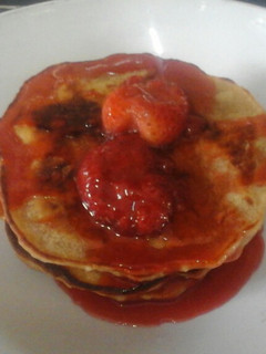 A picture of Vegan Pancakes with Strawberry sauce.