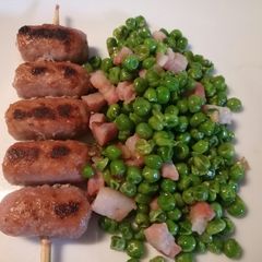 A picture of Mini sausage skewers with pancetta and peas.