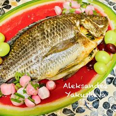 A picture of Tilapia baked with carrots and onions.
