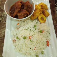 A picture of Rice and chicken stew with plantain. My love for rice and stew.