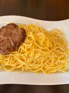 Una foto de Fideos tallarín con salsa huancaina y hamburguesa casera