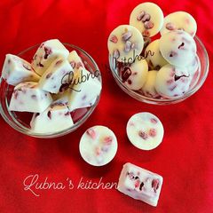 A picture of Frozen greek yogurt and pomegranate cubes.