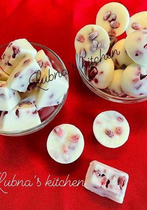 A picture of Frozen greek yogurt and pomegranate cubes.
