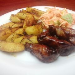 A picture of Garlic,rosemary potato wedges with sticky wings.