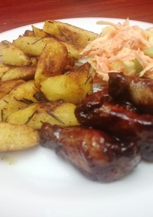 A picture of Garlic,rosemary potato wedges with sticky wings.