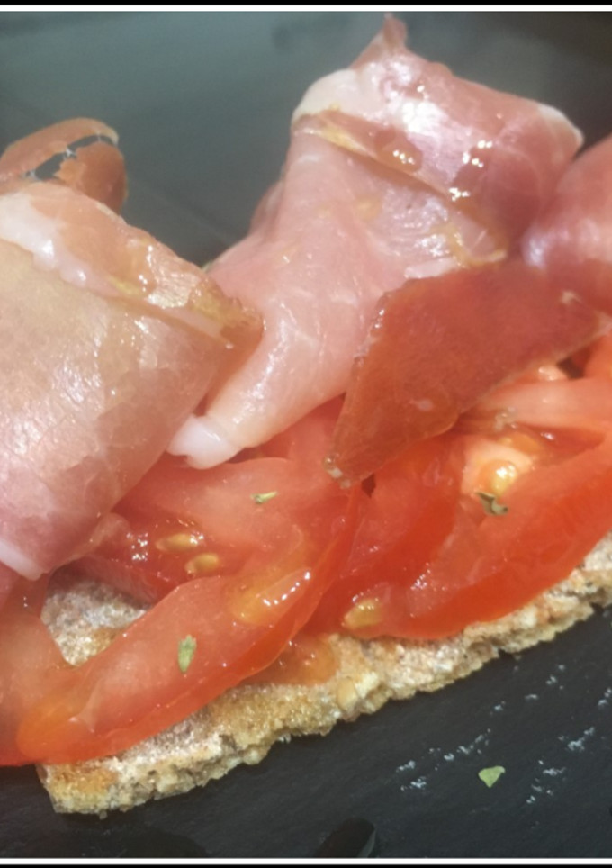 Una foto de Tostada integral con tomate y serrano