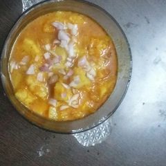 A picture of Potatoes and tomatoes sweetened sour vegetable.
