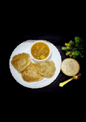 A picture of Poori- aloo curry and kheer.