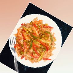 A picture of Pasta with green veggies and schezwan chutney.