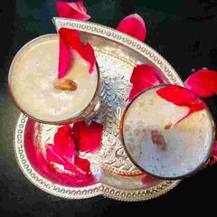 A picture of Thandai with rose petals.