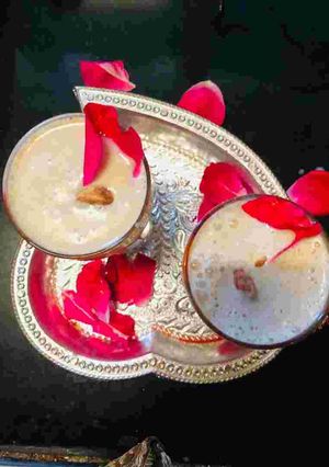 A picture of Thandai with rose petals.