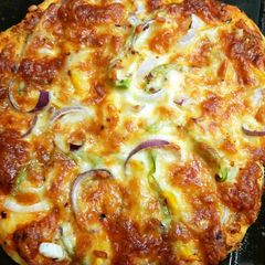 A picture of Pizza with fresh pizza dough.