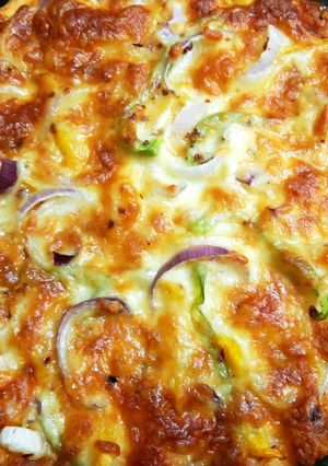 A picture of Pizza with fresh pizza dough.