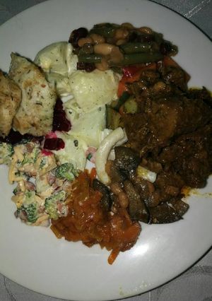 A picture of Delicious beef stew,fried fish and salads.