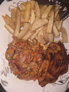 A picture of Fried yam with plantain and egg sauce.