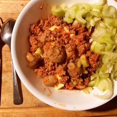 A picture of Sweet sour Mushroom mince meat served with cheese and celery toppings.